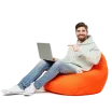 Man sitting in chair on bean bag at home